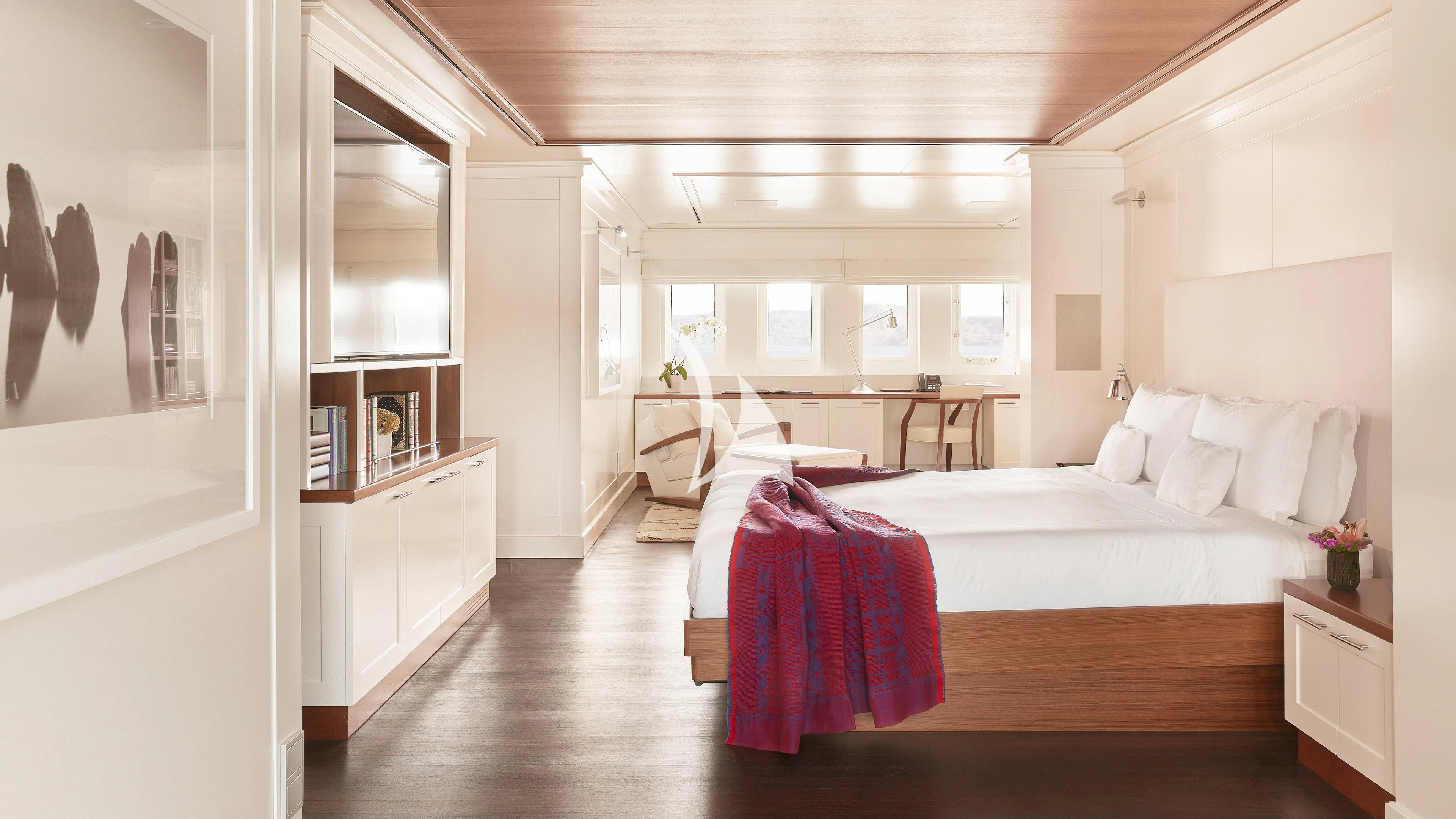 a bedroom with a bed and a desk aboard SENSES Yacht for Sale