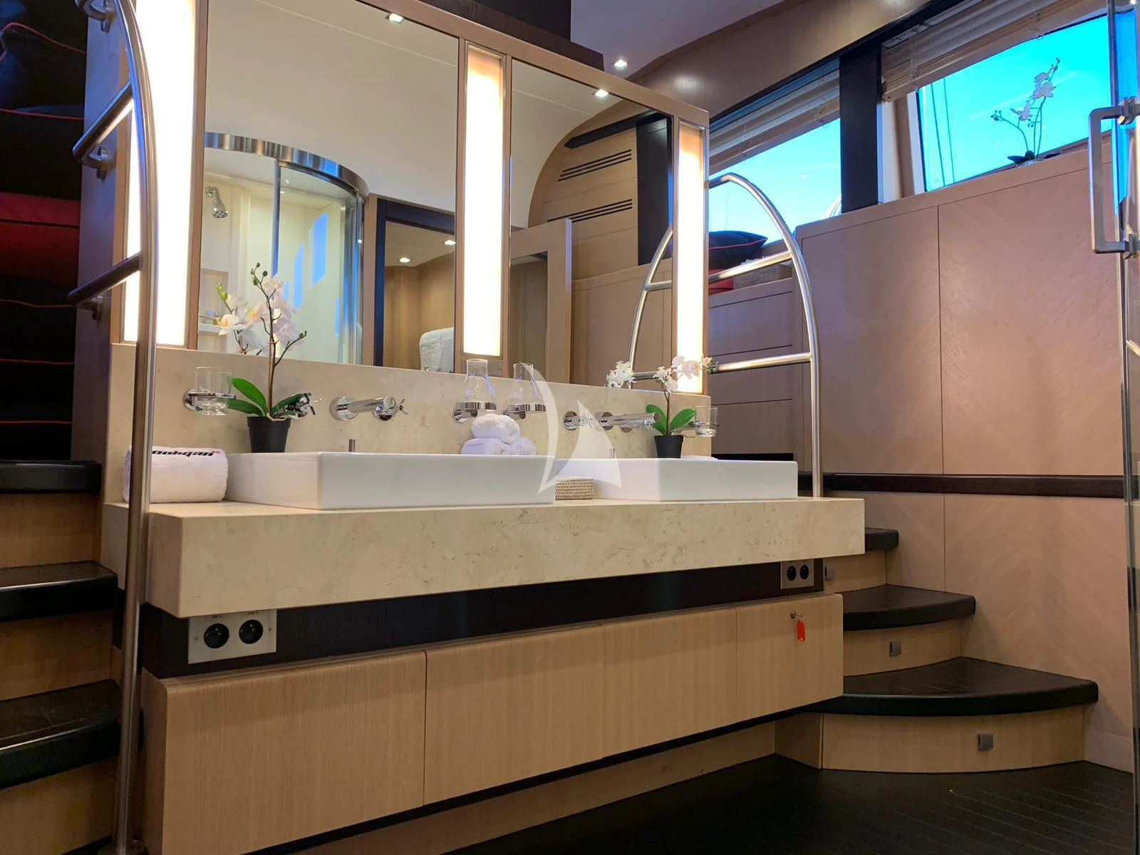 a bathroom with a large mirror aboard YCM 120 Yacht for Charter