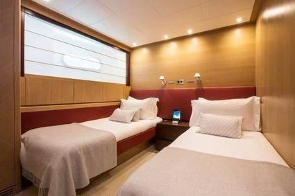 a room with two beds aboard YCM 120 Yacht for Charter