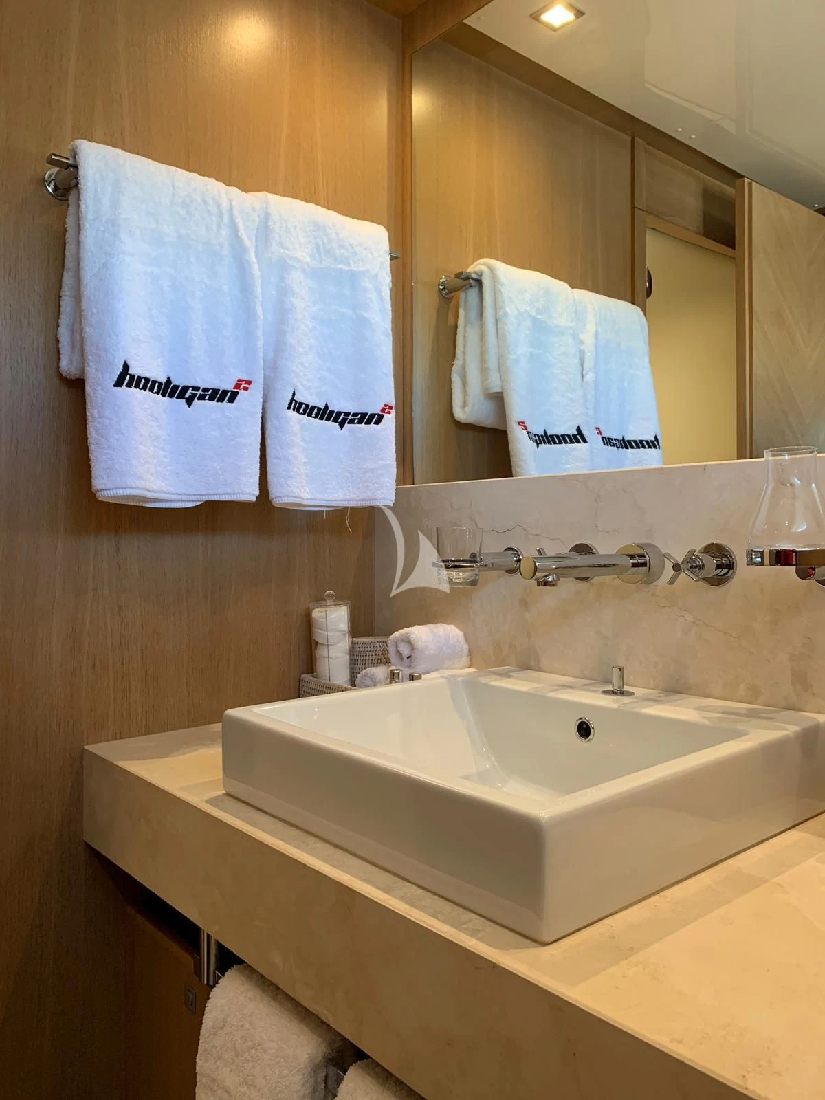 a bathroom with a sink and towels aboard YCM 120 Yacht for Charter
