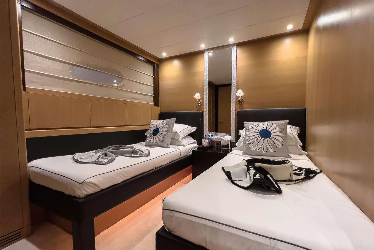 a room with two beds aboard YCM 120 Yacht for Charter