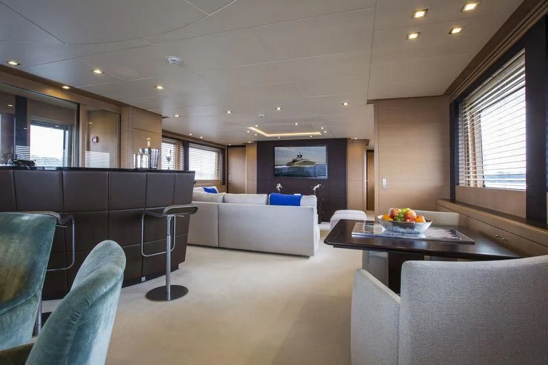 a living room with a couch and a coffee table aboard YCM 120 Yacht for Charter