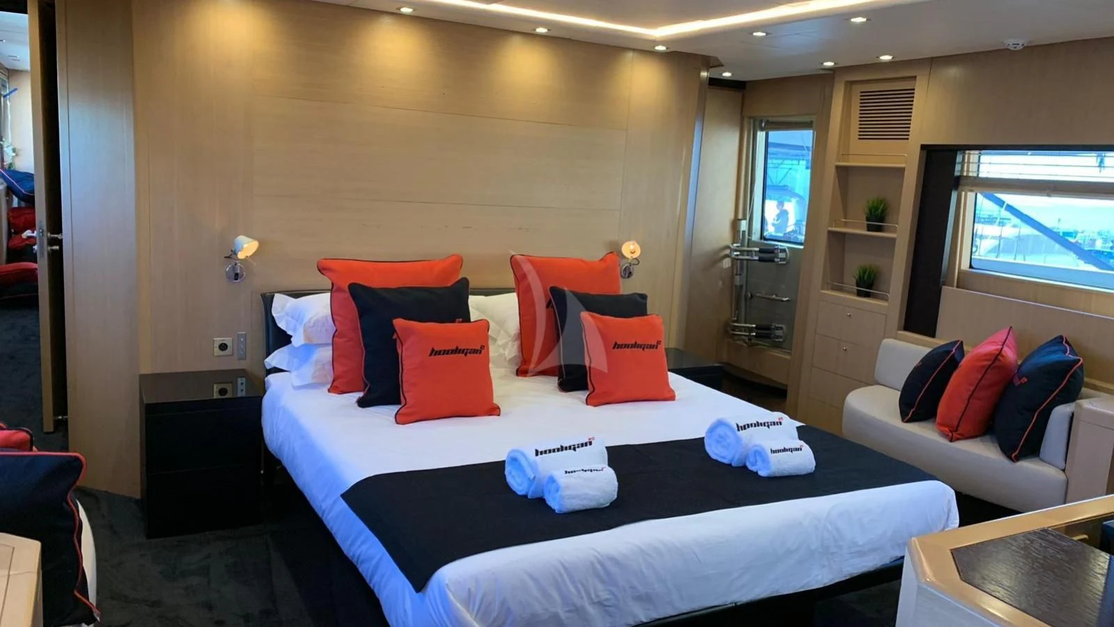 a bed with pillows on it aboard YCM 120 Yacht for Charter