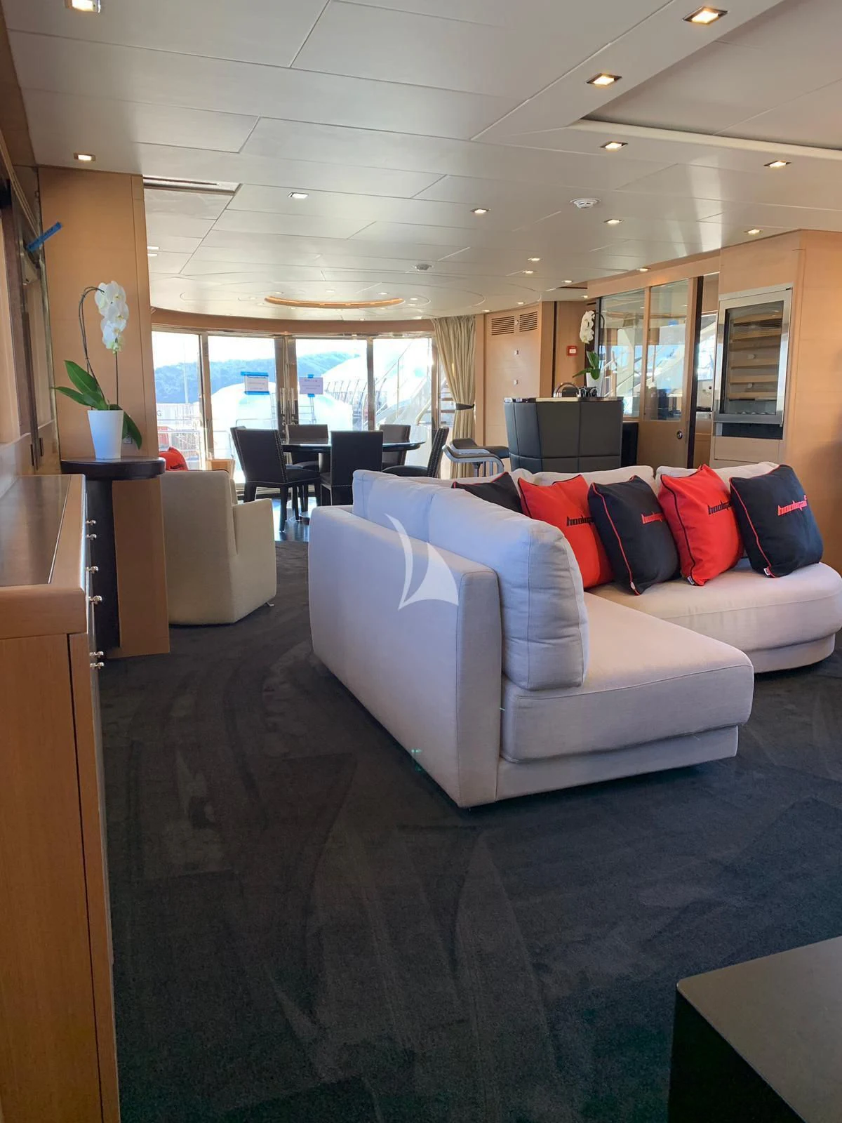 a living room with a couch and a table aboard YCM 120 Yacht for Charter