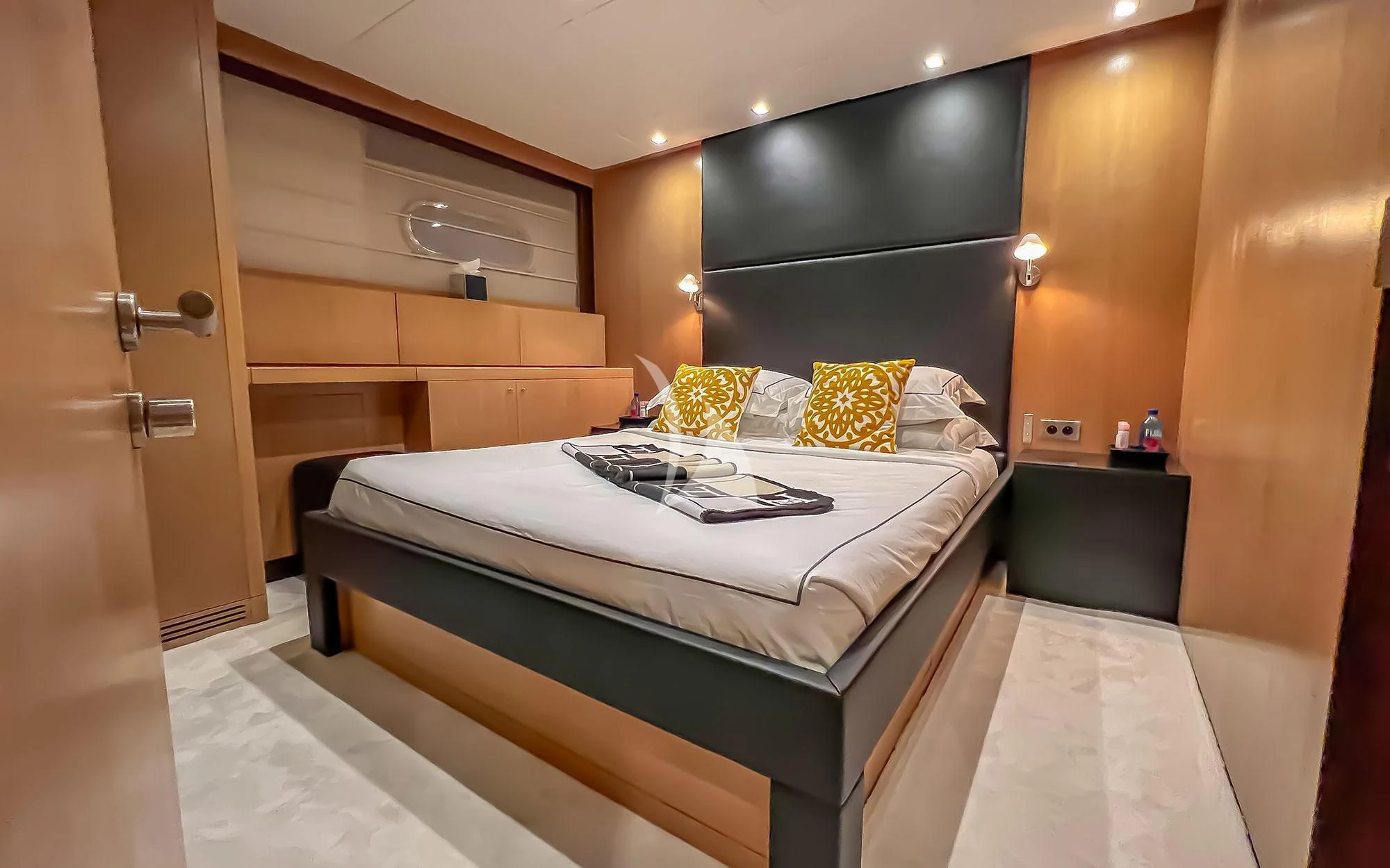 a bedroom with a bed and a desk aboard YCM 120 Yacht for Charter