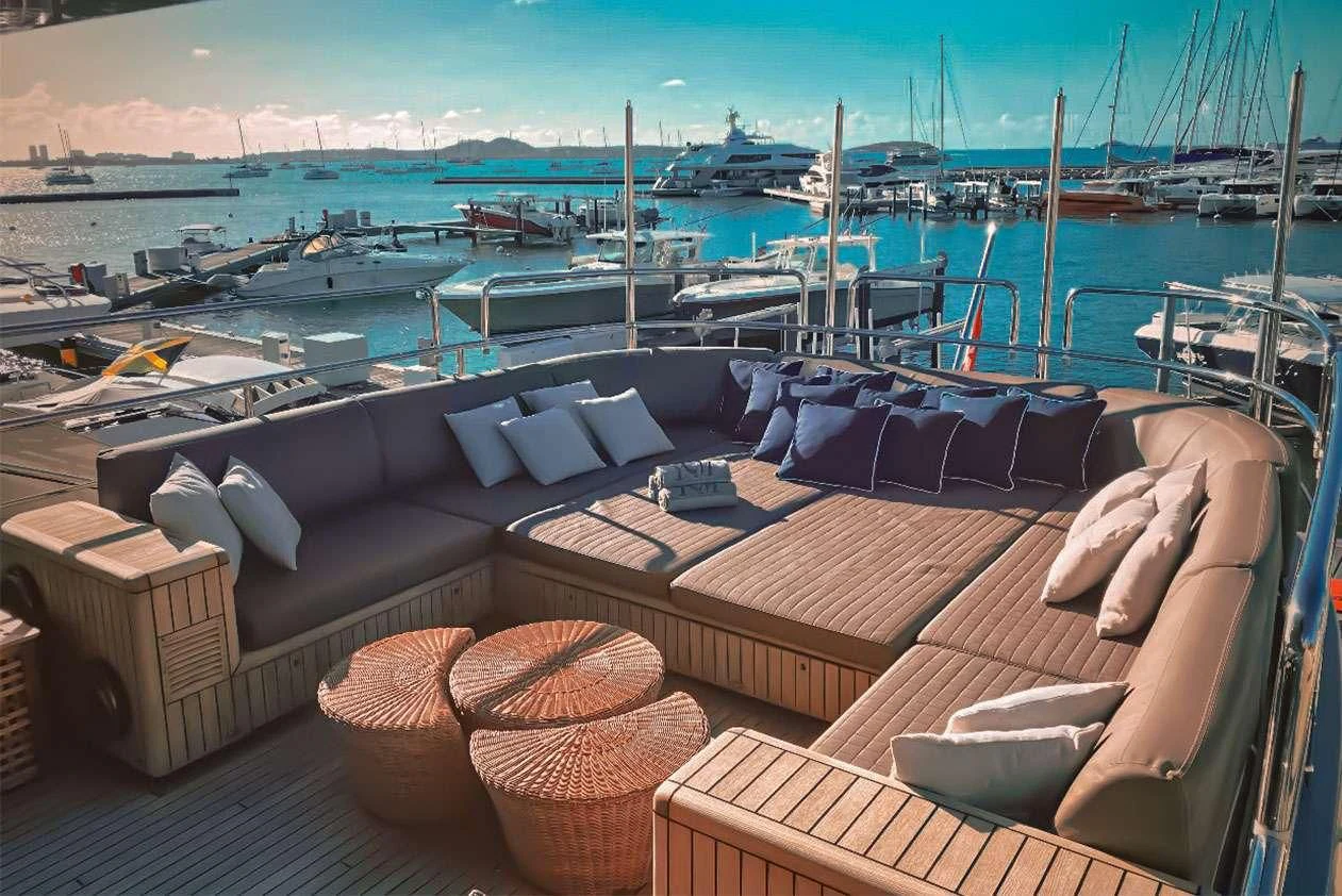 a deck with many chairs and boats aboard YCM 120 Yacht for Charter