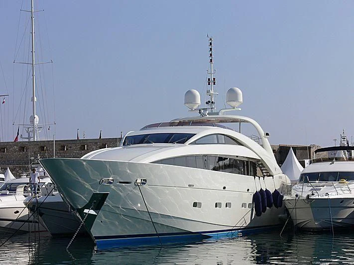 a large white boat in a harbor aboard YCM 120 Yacht for Charter