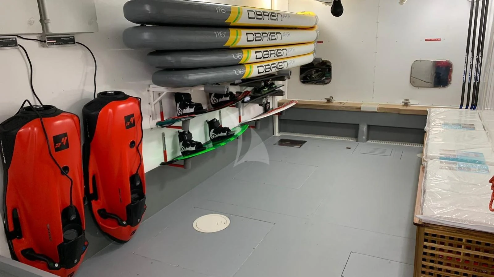 a room with a red suitcase and a white table with a white wall aboard YCM 120 Yacht for Charter