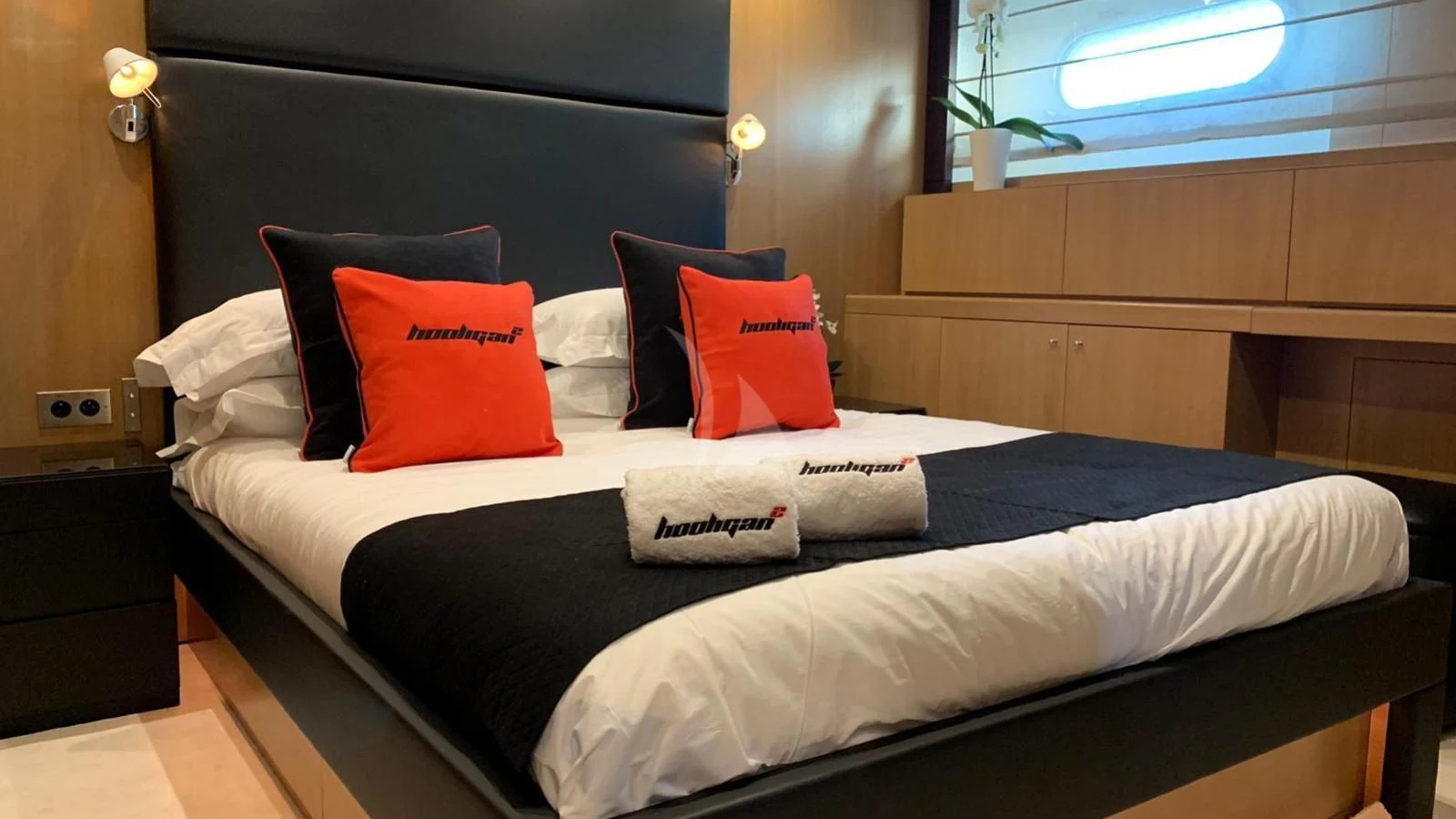 a bed with pillows aboard YCM 120 Yacht for Charter