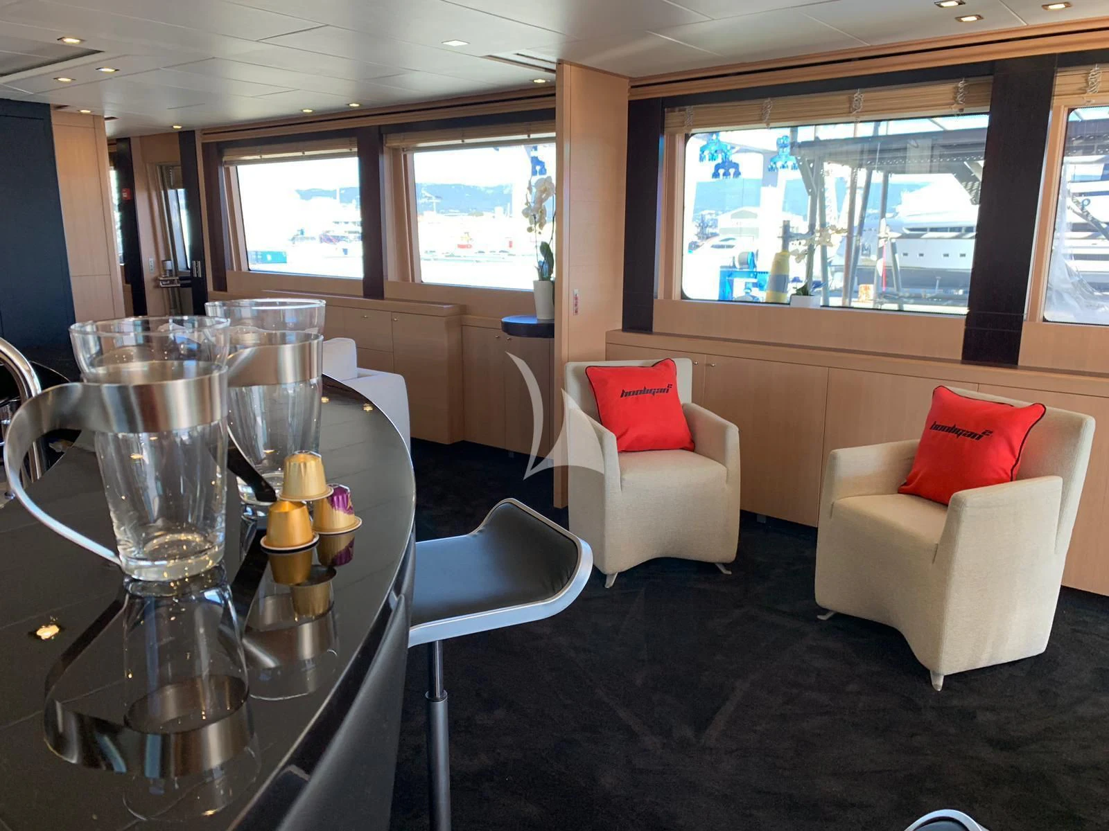 a living room with a table and chairs aboard YCM 120 Yacht for Charter
