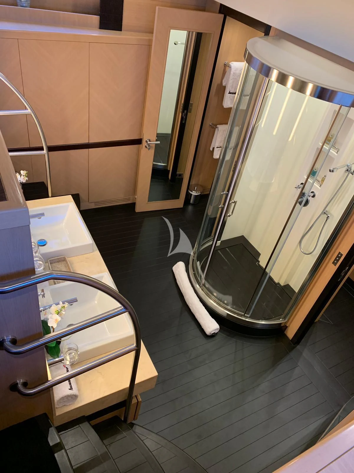 a bathroom with a large glass shower aboard YCM 120 Yacht for Charter