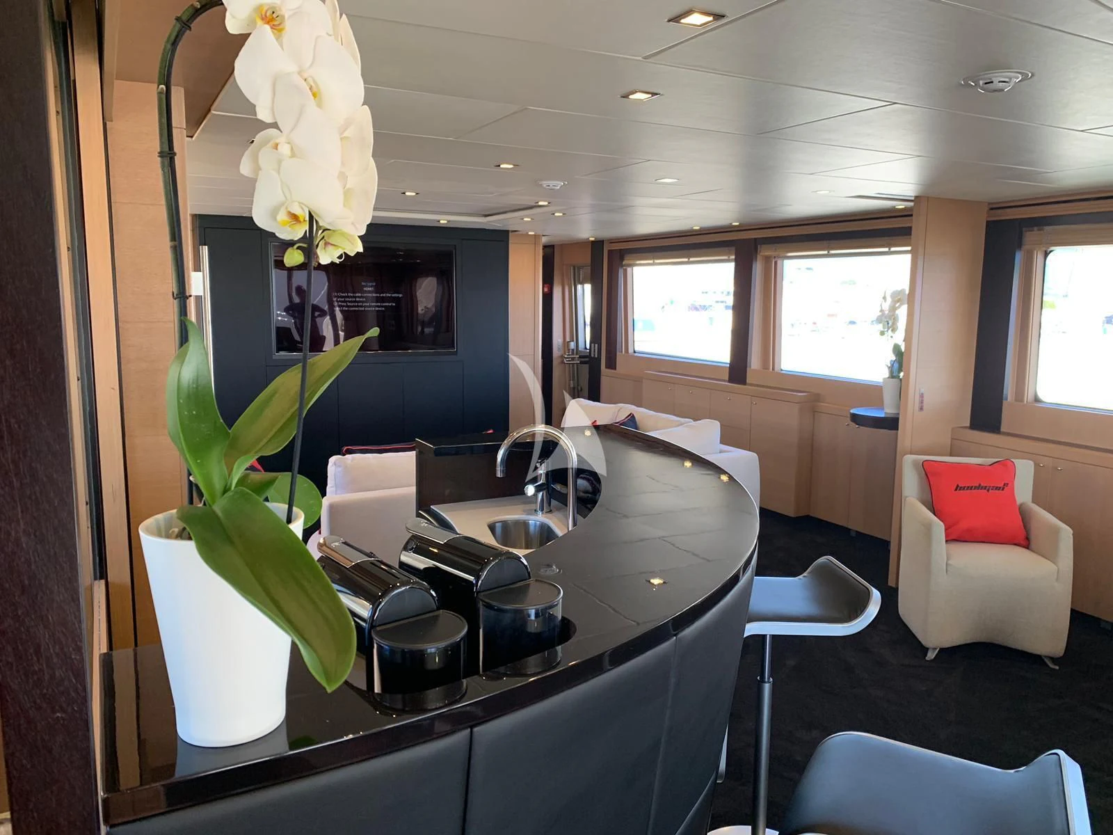 a kitchen with a table and chairs aboard YCM 120 Yacht for Charter