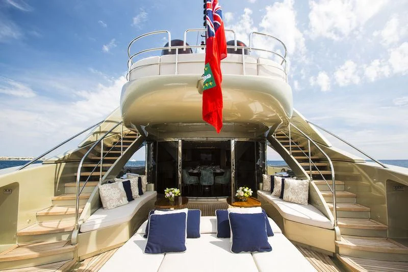 a large cruise ship with a red flag on the deck aboard YCM 120 Yacht for Charter