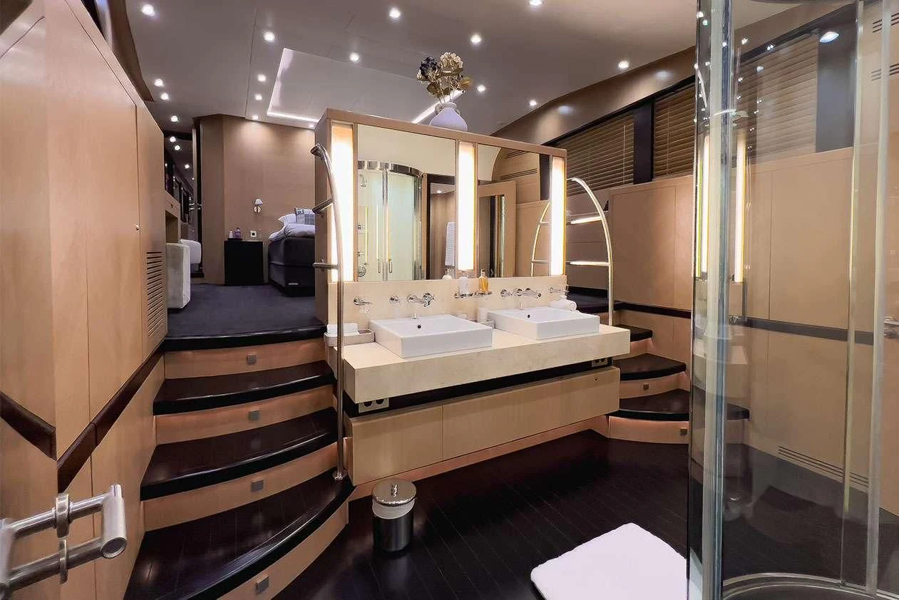 a bathroom with a large mirror aboard YCM 120 Yacht for Charter