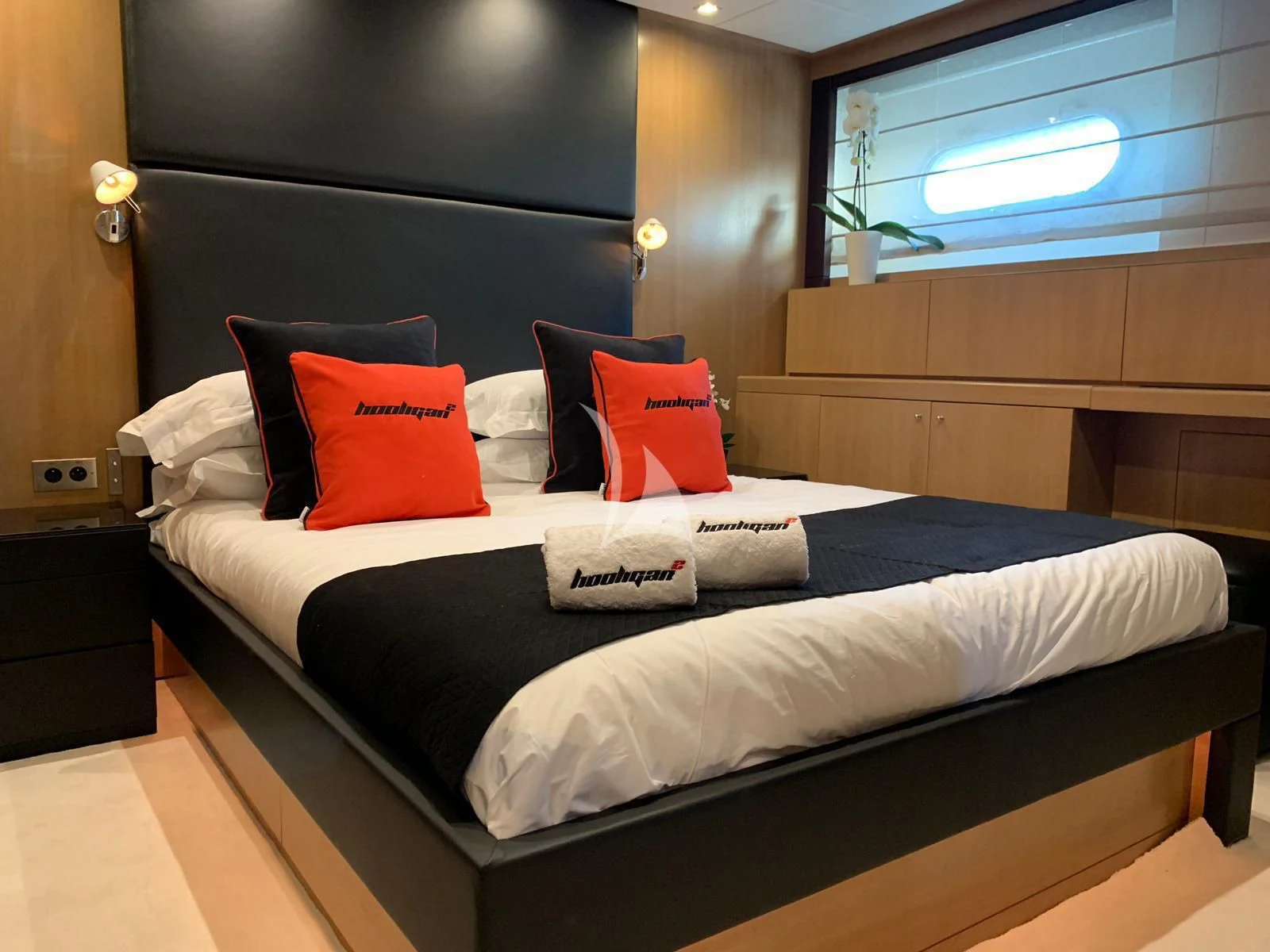 a bed with pillows on it aboard YCM 120 Yacht for Charter