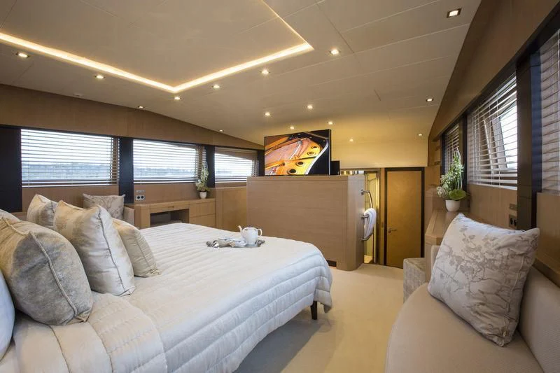 a bedroom with a bed and a couch aboard YCM 120 Yacht for Charter