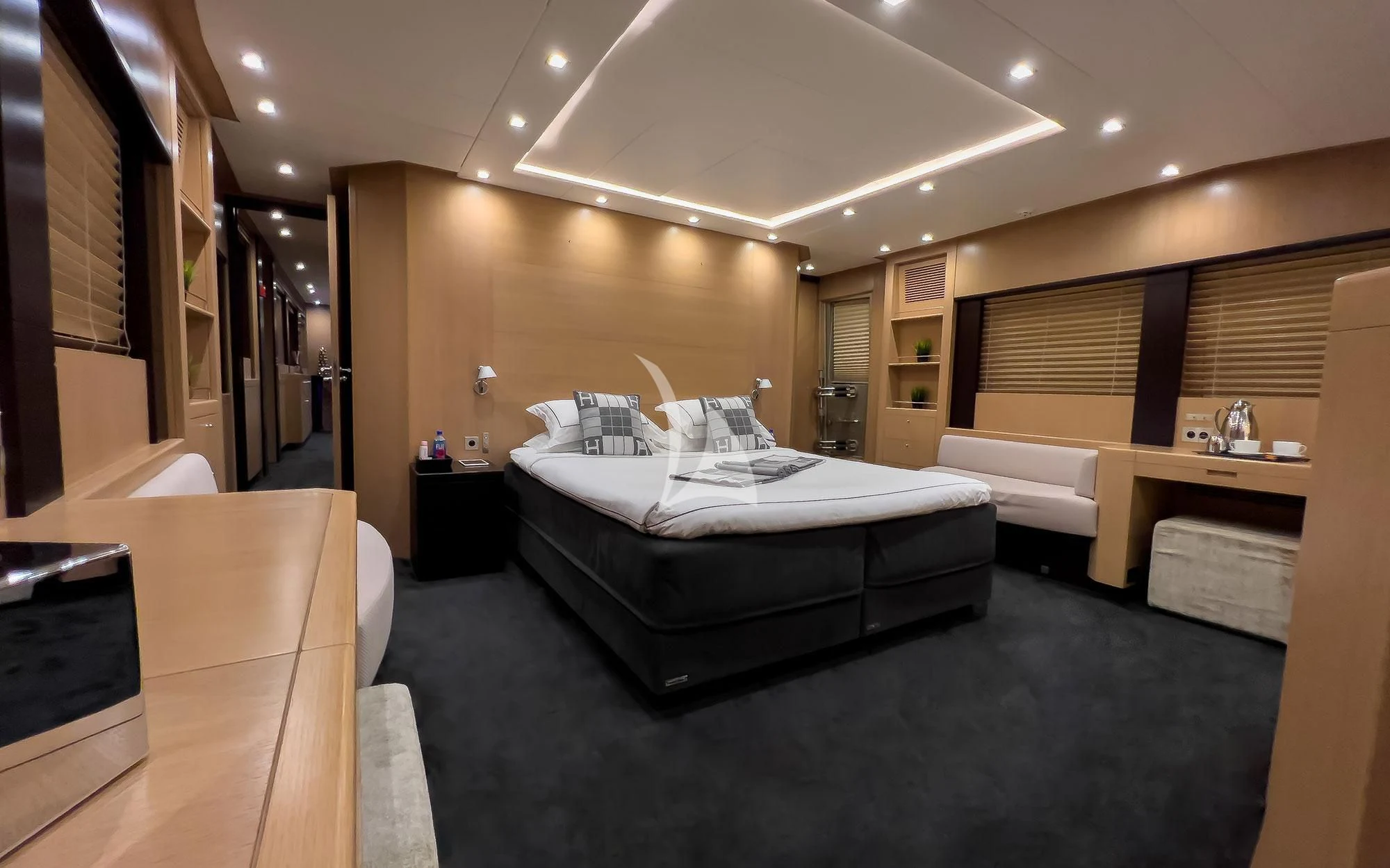 a room with a bed and a desk aboard YCM 120 Yacht for Charter