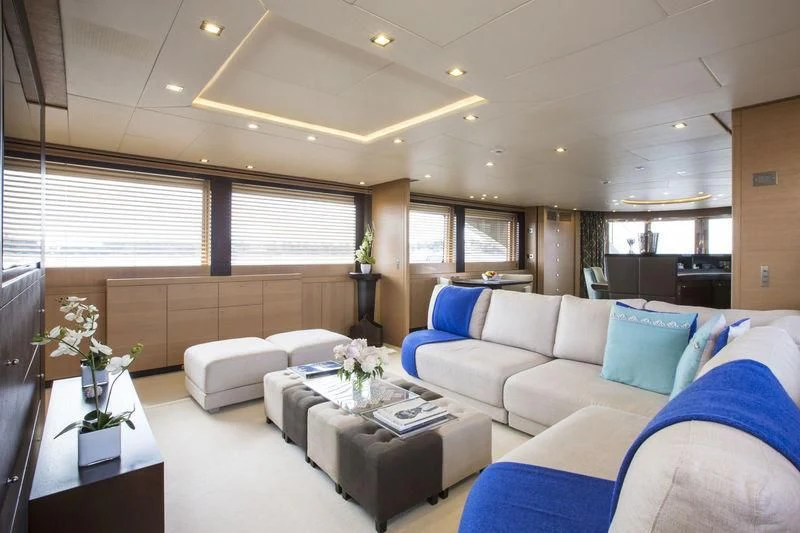 a living room with a couch and a table aboard YCM 120 Yacht for Charter
