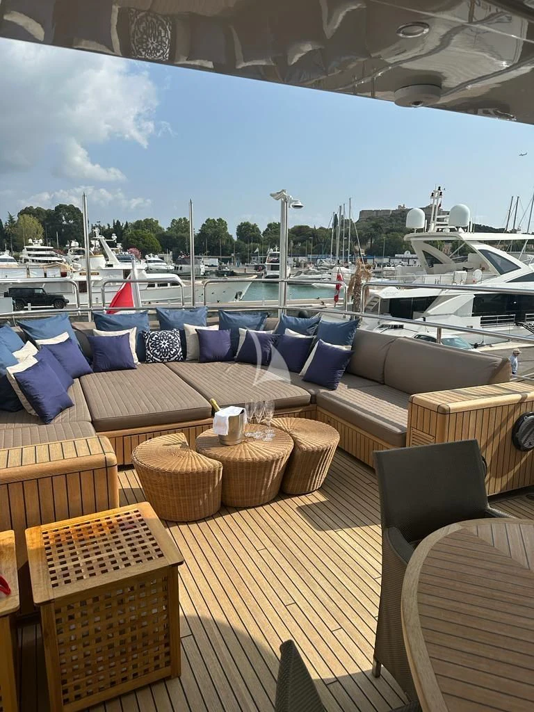 a patio with a table and chairs aboard YCM 120 Yacht for Charter