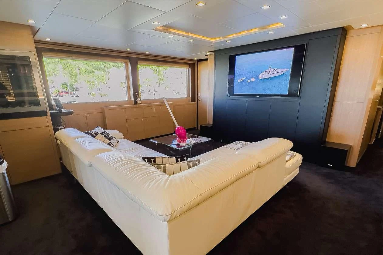 a bedroom with a bed and a coffee table aboard YCM 120 Yacht for Charter