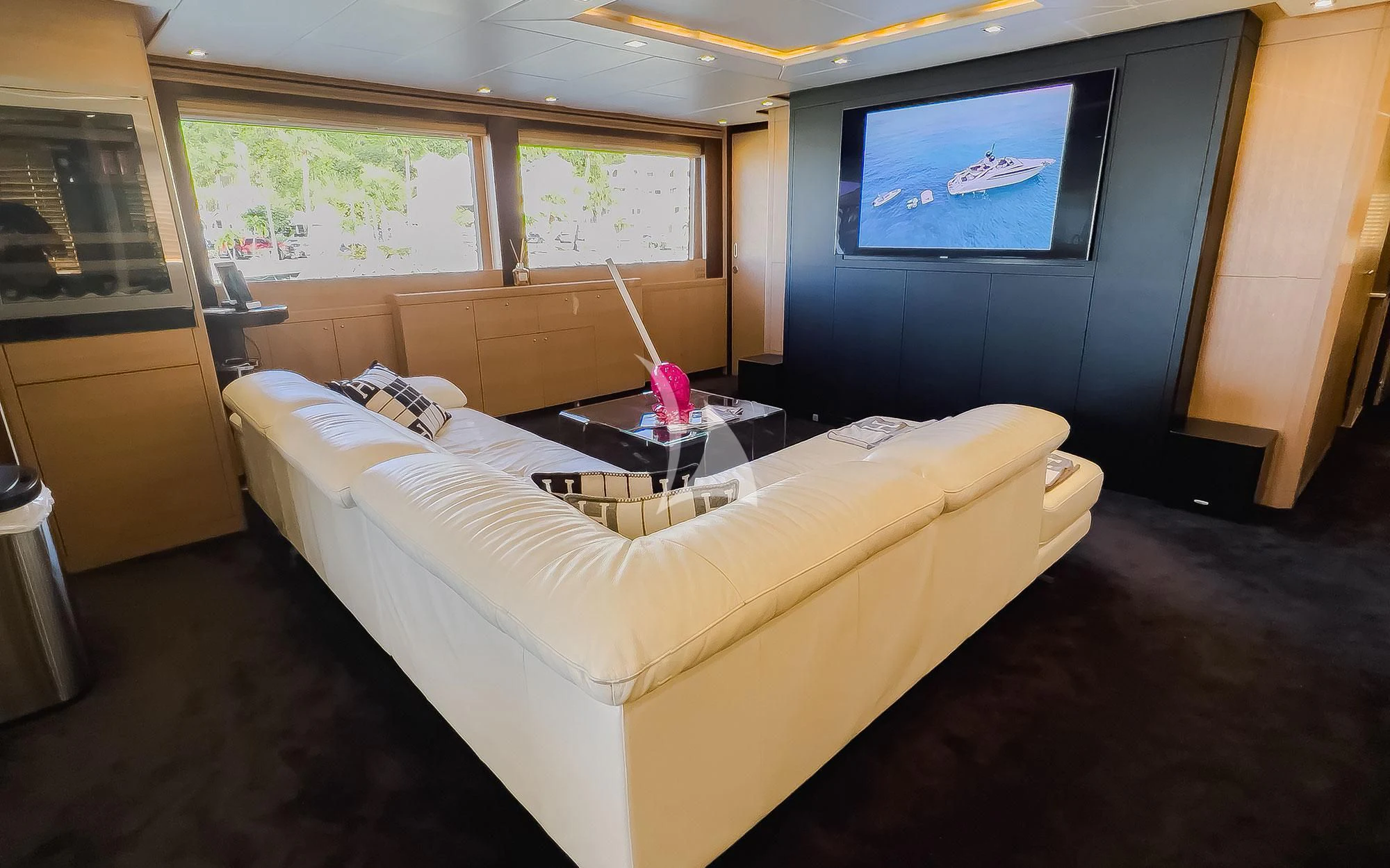 a bedroom with a bed and a coffee table aboard YCM 120 Yacht for Charter