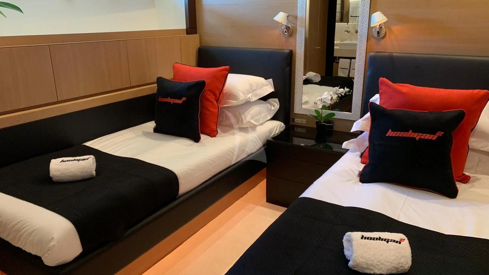 a room with a bed and a mirror aboard YCM 120 Yacht for Charter