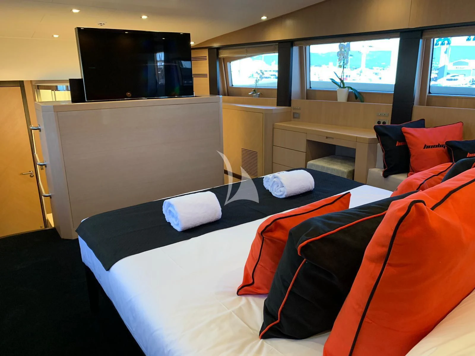 a room with a bed and tv aboard YCM 120 Yacht for Charter