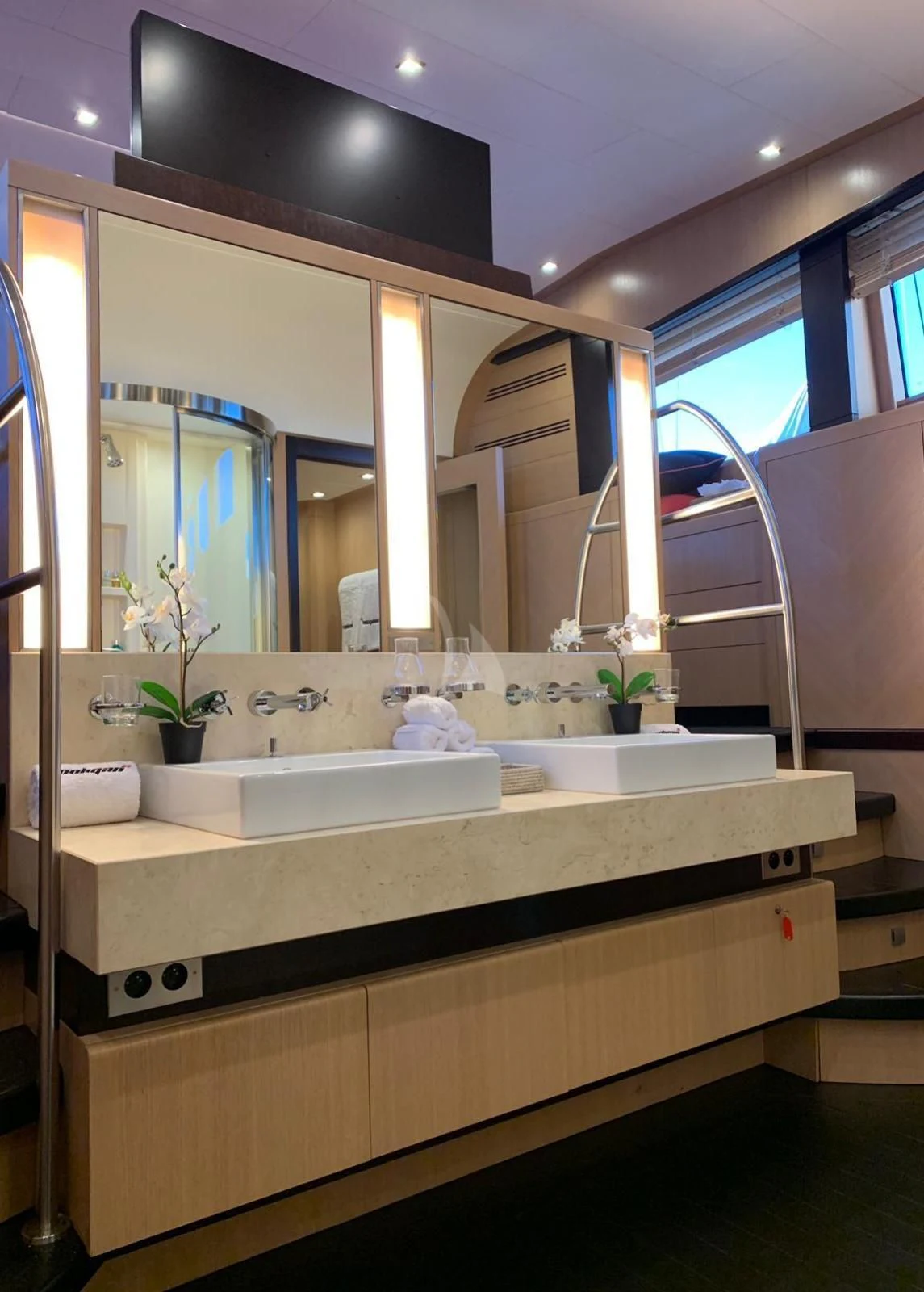 a bathroom with a large mirror aboard YCM 120 Yacht for Charter