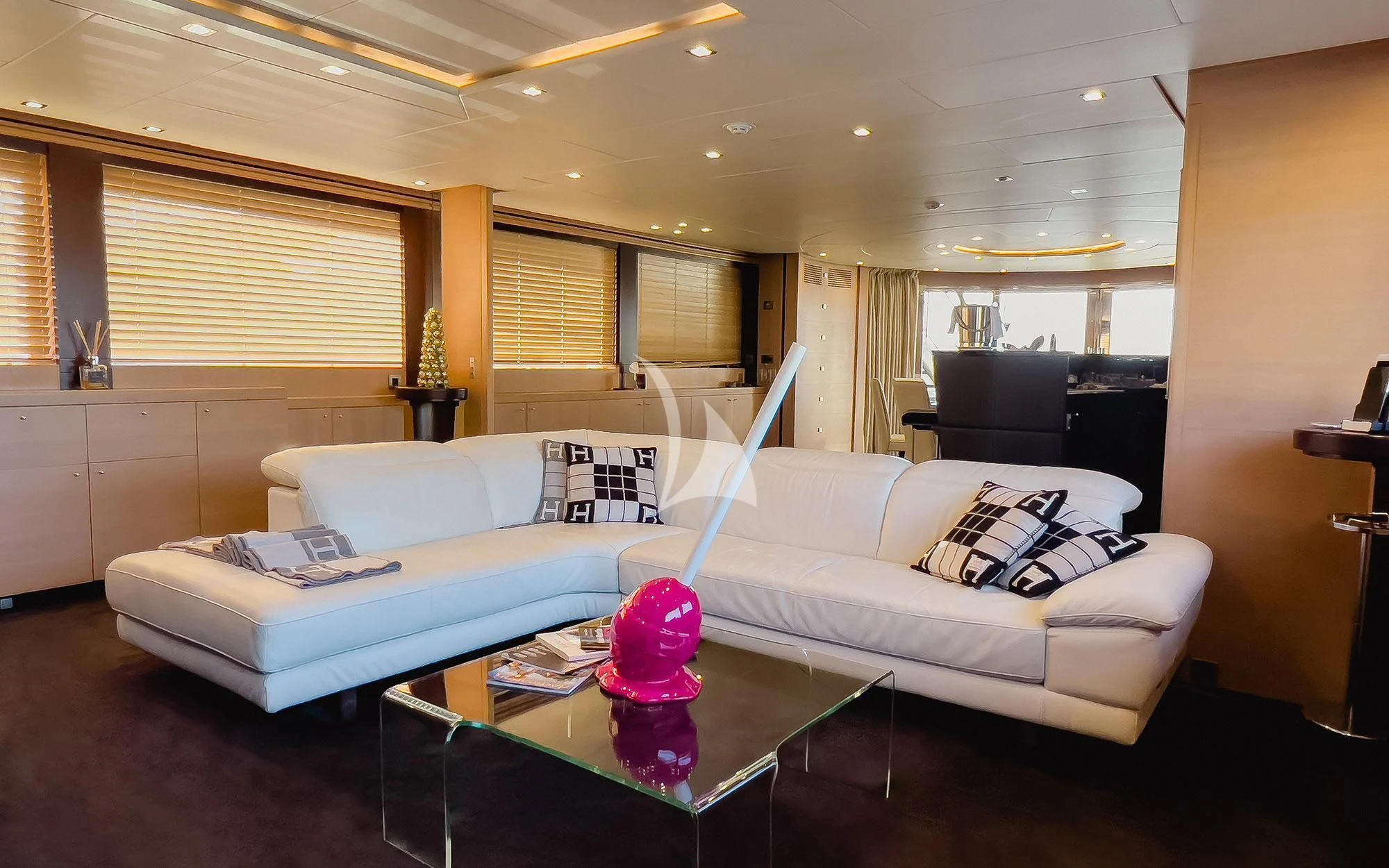 a living room with a white couch and a coffee table aboard YCM 120 Yacht for Charter