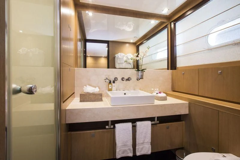 a bathroom with a large mirror aboard YCM 120 Yacht for Charter