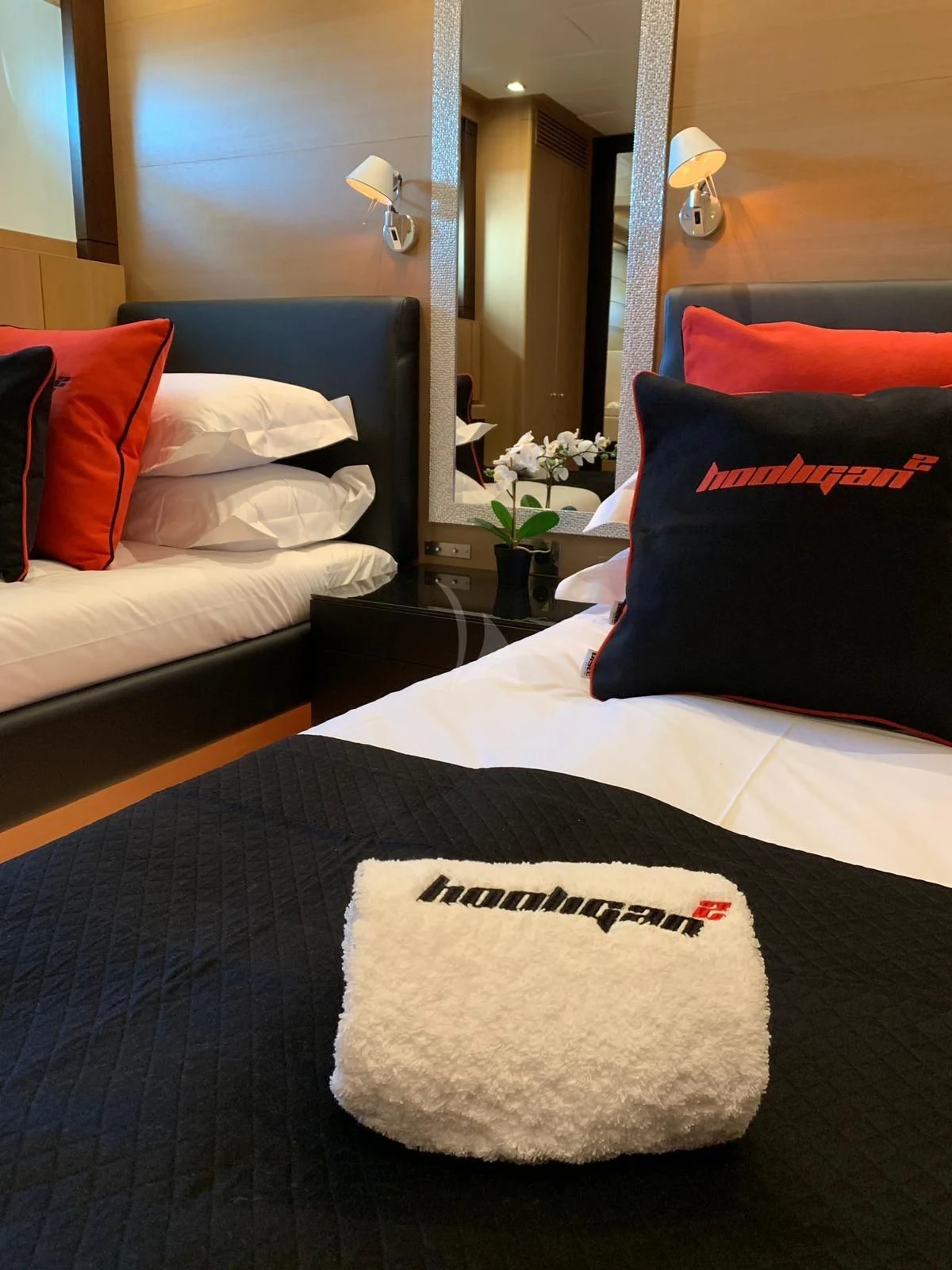 a bed with pillows aboard YCM 120 Yacht for Charter