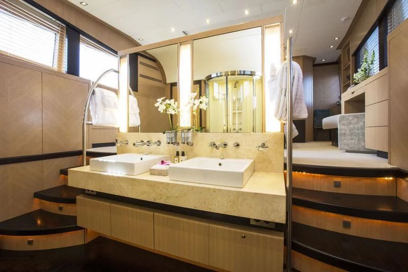 a bathroom with a large mirror aboard YCM 120 Yacht for Charter