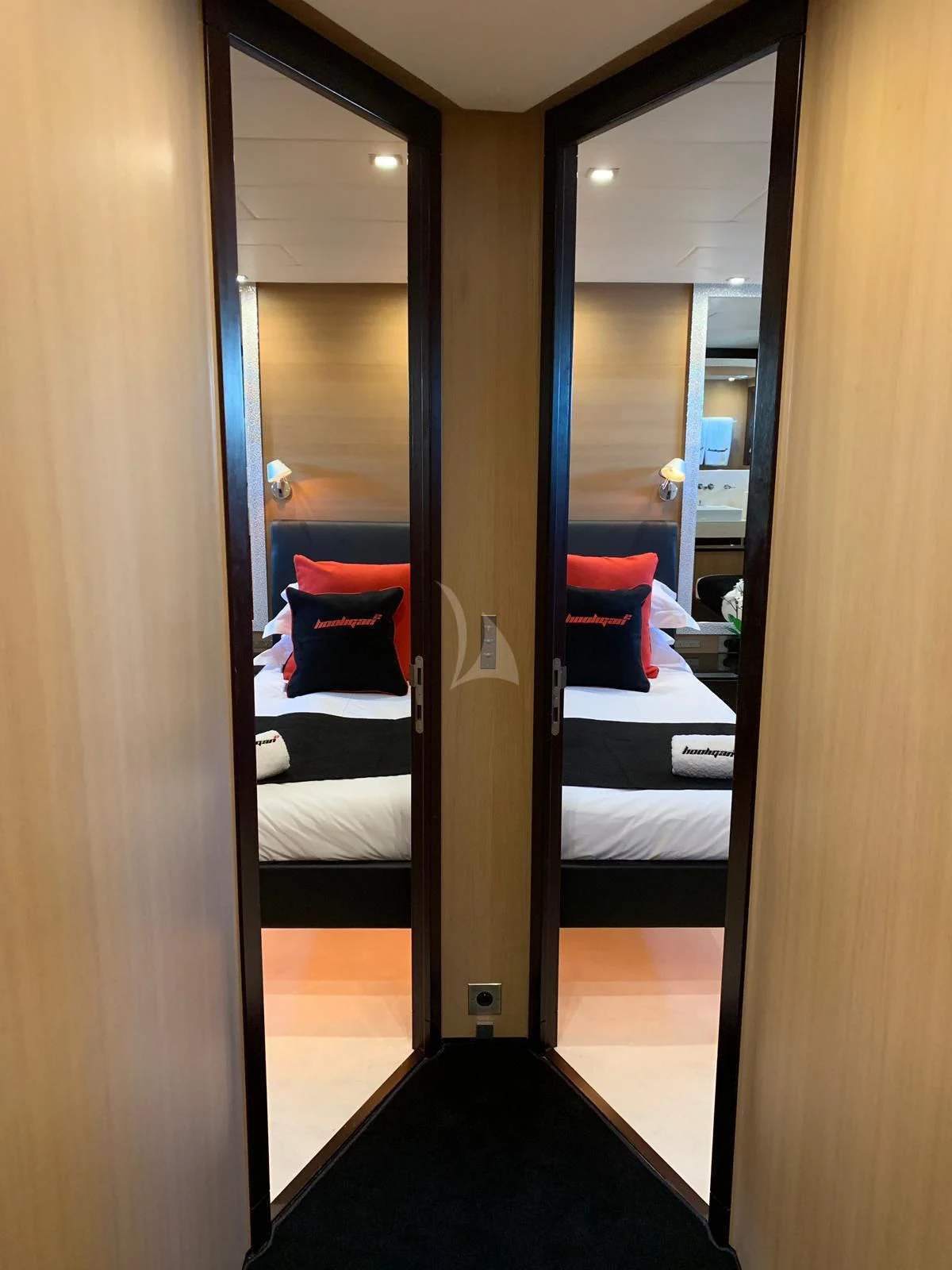 a room with a bed and a mirror aboard YCM 120 Yacht for Charter