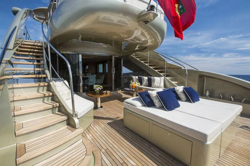 a large white bed on a deck aboard YCM 120 Yacht for Charter