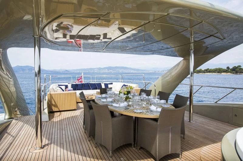 a table set for a meal on a boat aboard YCM 120 Yacht for Charter