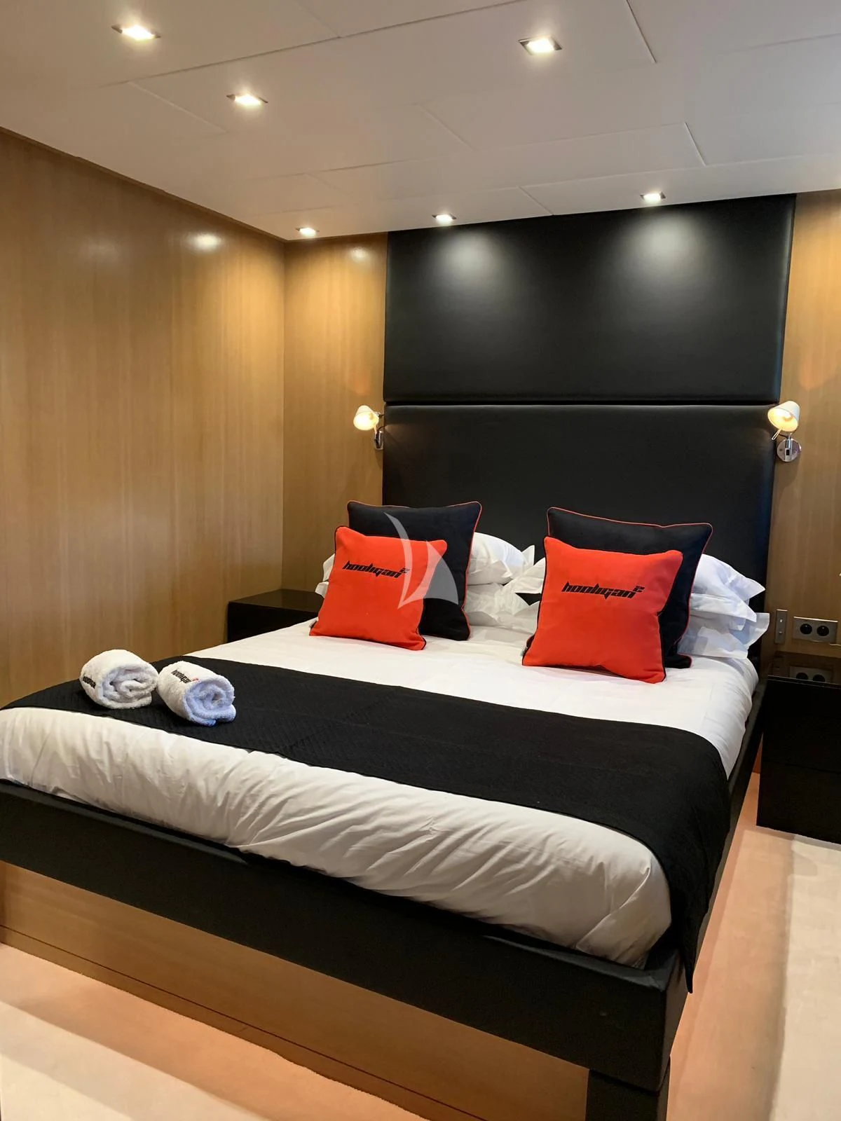 a bed with pillows on it aboard YCM 120 Yacht for Charter
