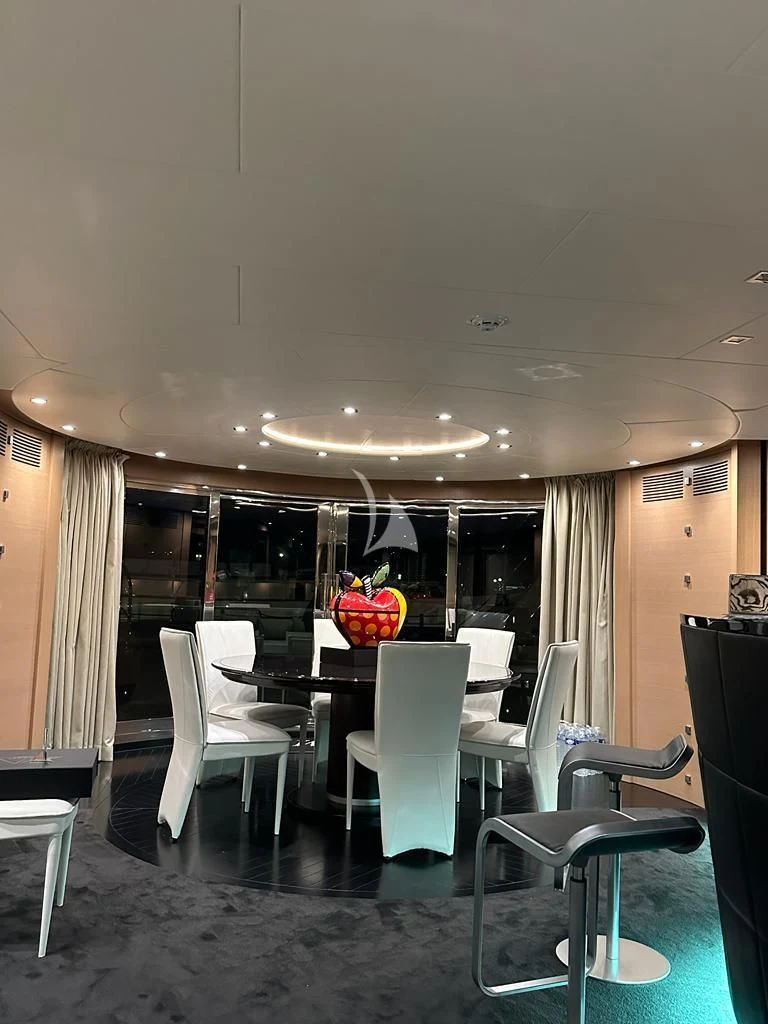 a room with a table chairs and a window aboard YCM 120 Yacht for Charter