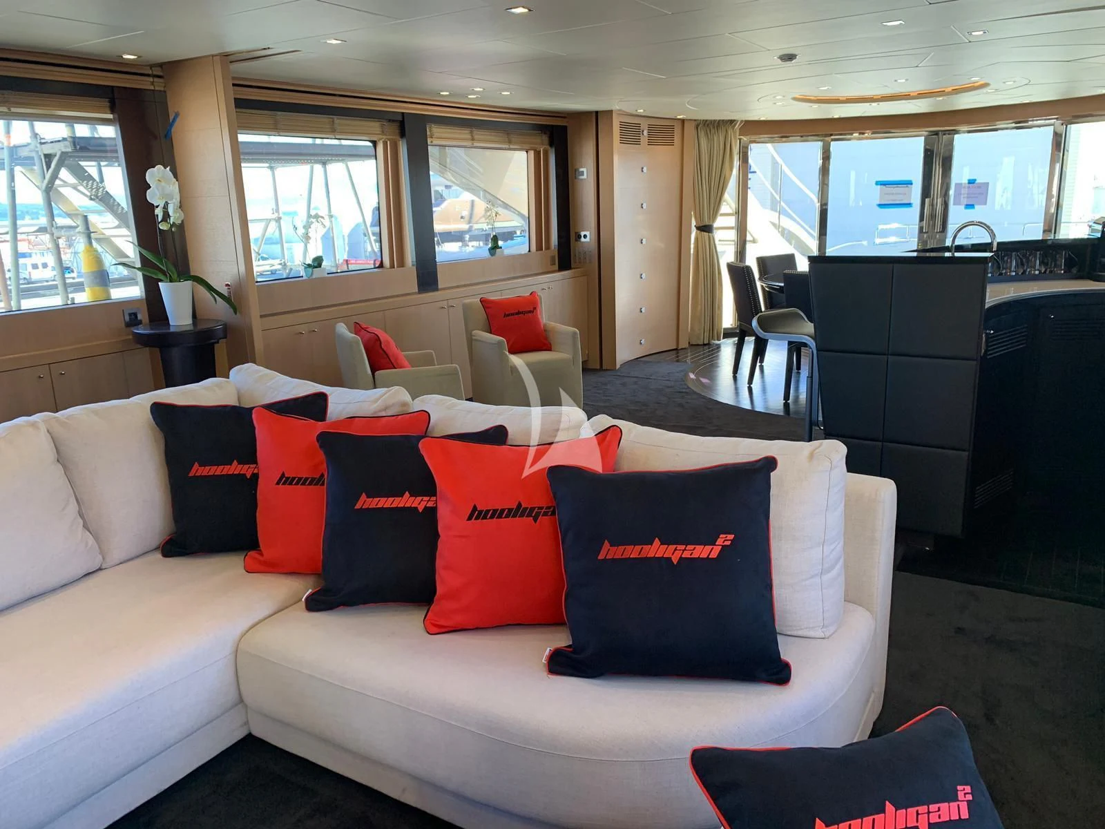 a white couch with pillows aboard YCM 120 Yacht for Charter