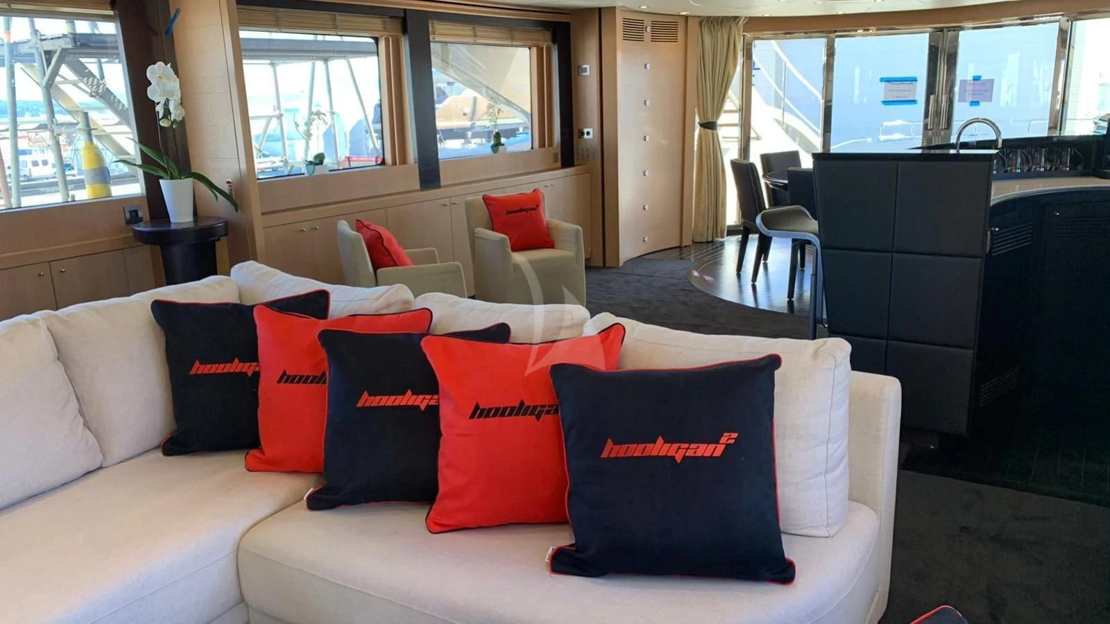 a white couch with pillows aboard YCM 120 Yacht for Charter