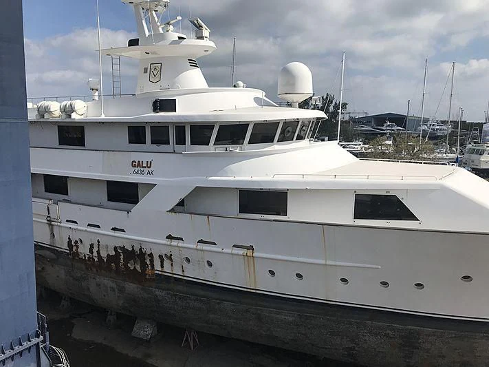 a white yacht on a dock aboard CONSERVATION Yacht for Sale