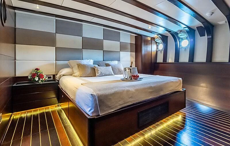 a room with a bed and a table aboard SEMAYA Yacht for Sale