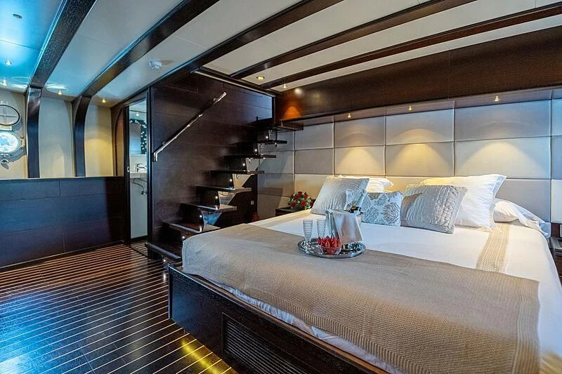 a room with a bed and a piano aboard SEMAYA Yacht for Sale