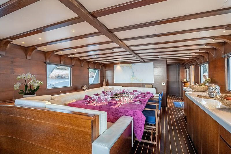 a room with a table and chairs aboard SEMAYA Yacht for Sale