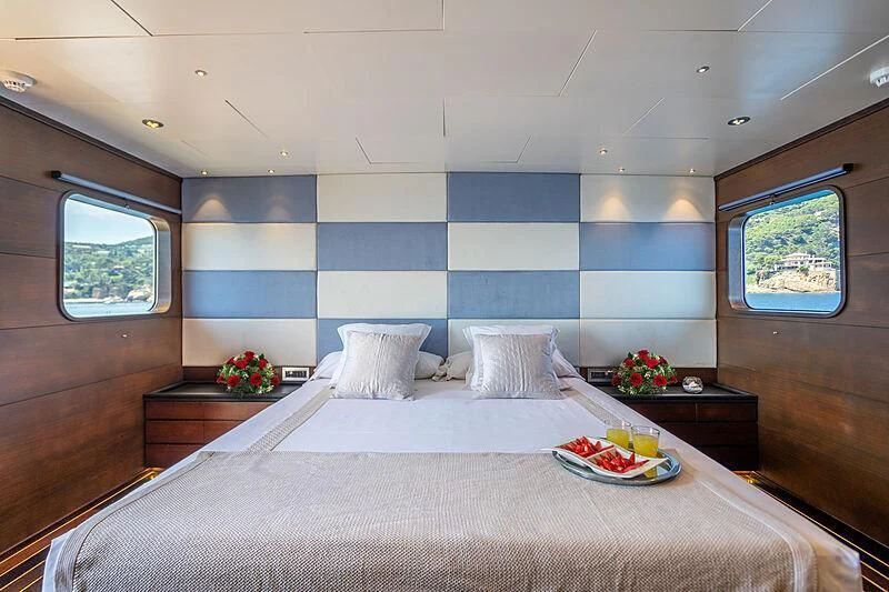 a bed with a tray of food aboard SEMAYA Yacht for Sale