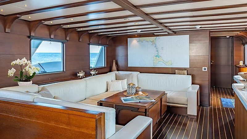 a room with a couch and a table aboard SEMAYA Yacht for Sale
