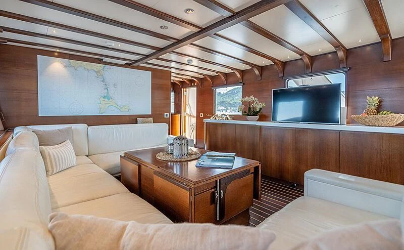 a living room with a couch and a tv aboard SEMAYA Yacht for Sale