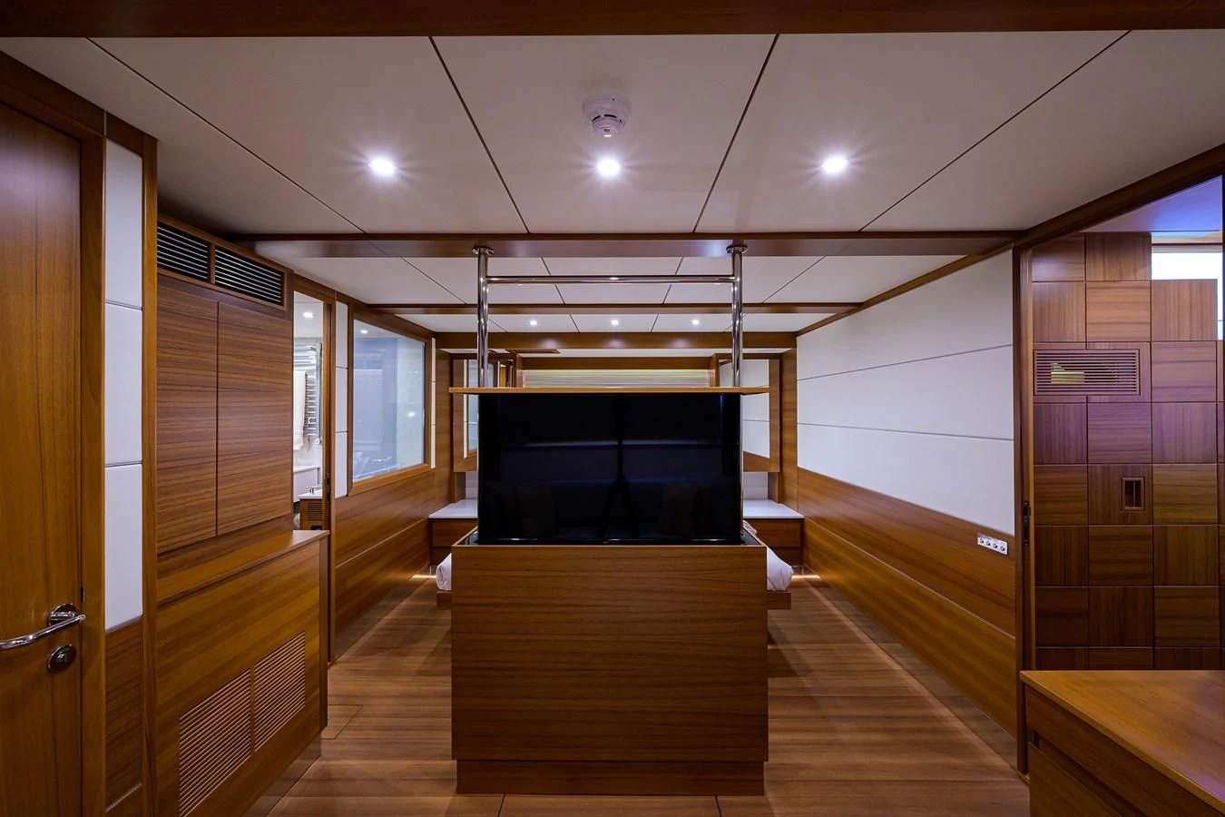 a room with a tv and a wood floor aboard SOCIAL DISTANCING Yacht for Sale
