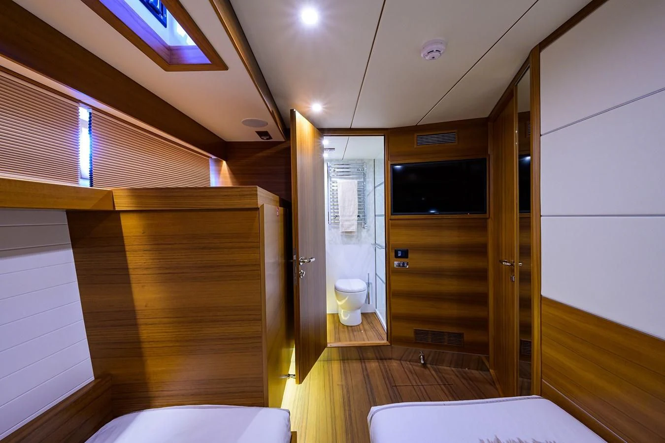 a room with a wood floor and a white urinal aboard SOCIAL DISTANCING Yacht for Sale