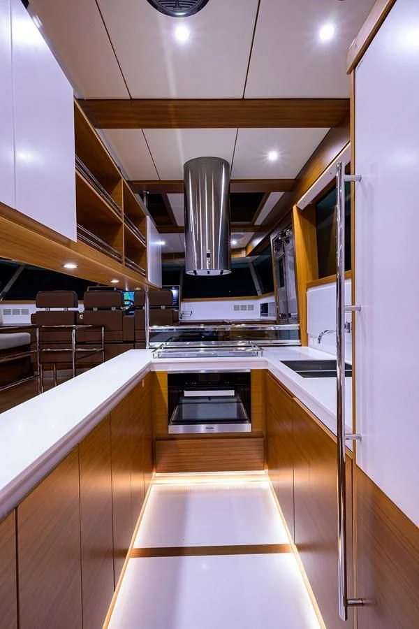 a kitchen with a large stainless steel stove and white cabinets aboard SOCIAL DISTANCING Yacht for Sale