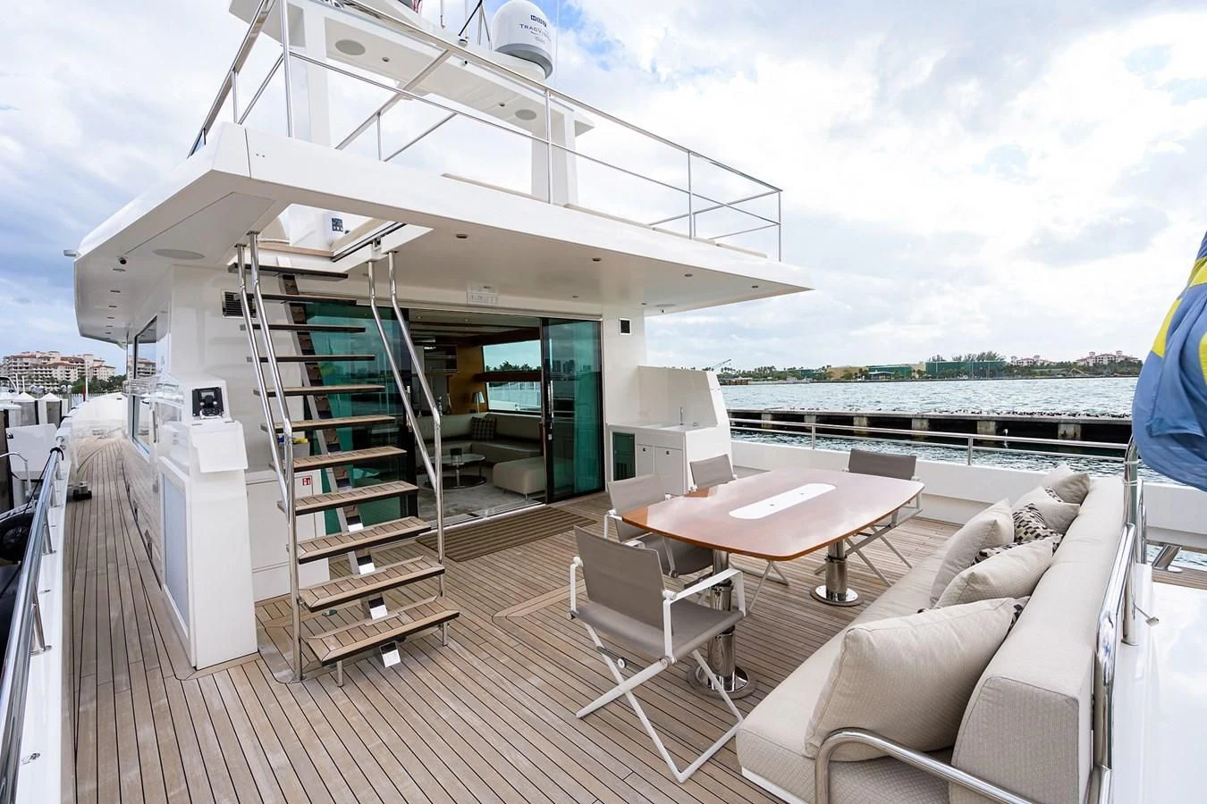 a deck with a table and chairs on it aboard SOCIAL DISTANCING Yacht for Sale